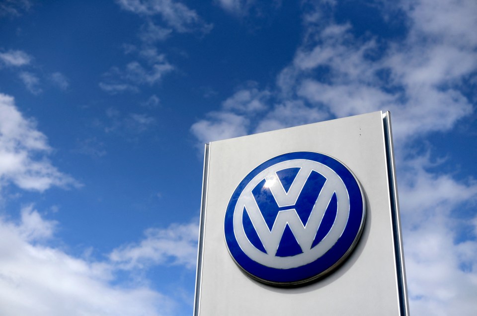 Volkswagen logo on a sign against a blue sky.