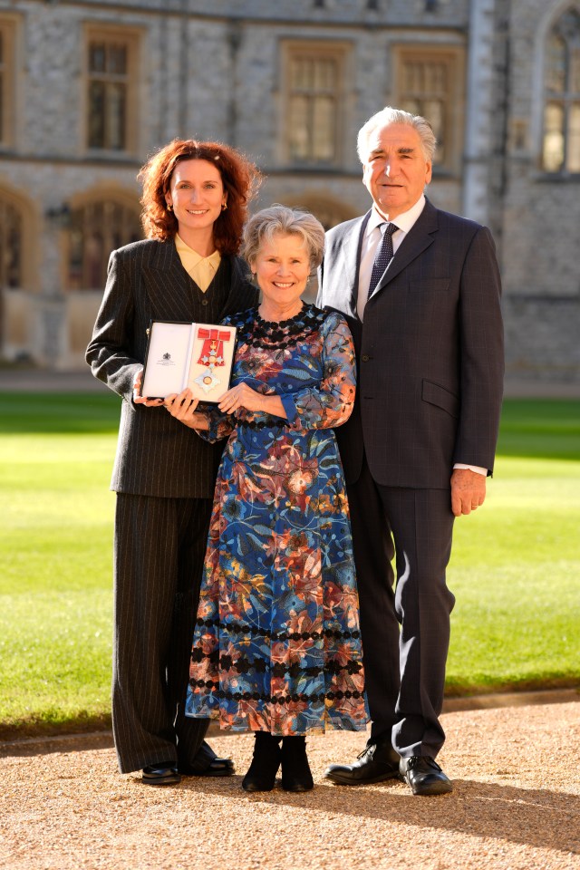 Dame Imelda Staunton with her husband and daughter after receiving an award.