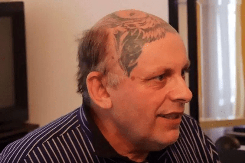Man with a large head tattoo.