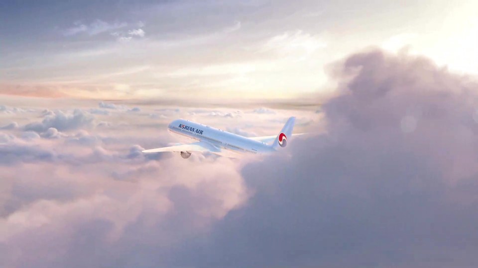 Korean Air plane flying above the clouds.