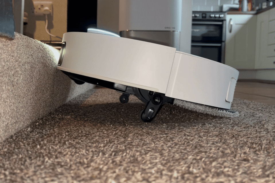 Dreame X50 robot vacuum cleaning under furniture.