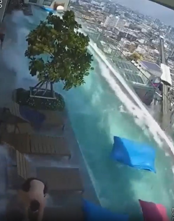 Pool water overflowing onto a rooftop deck during an earthquake.