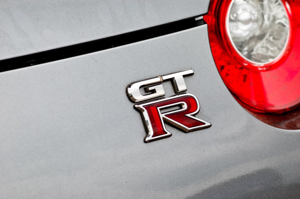 Nissan GT-R emblem on a silver car.
