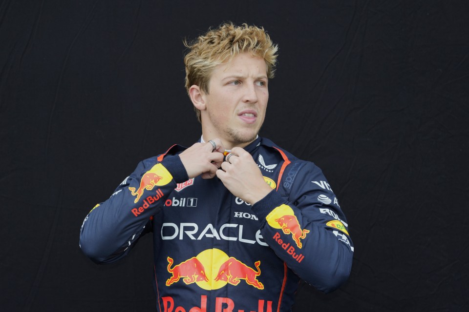 Liam Lawson, Red Bull driver, adjusting his racing suit.