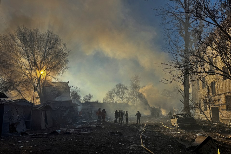 Rescuers at the site of a Russian missile strike in Kharkiv, Ukraine.