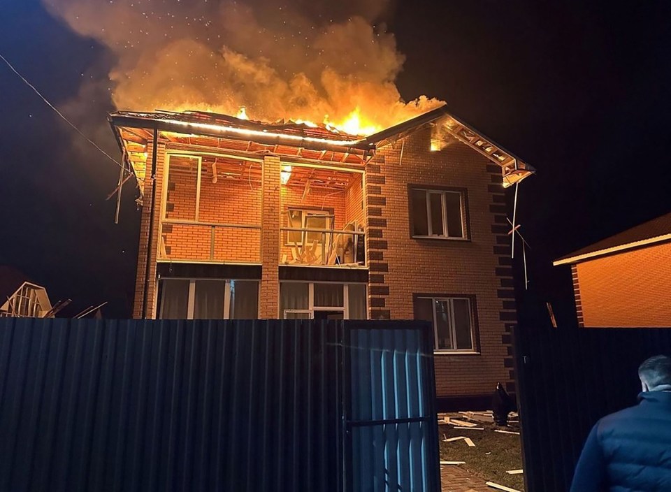 A burning house at night.