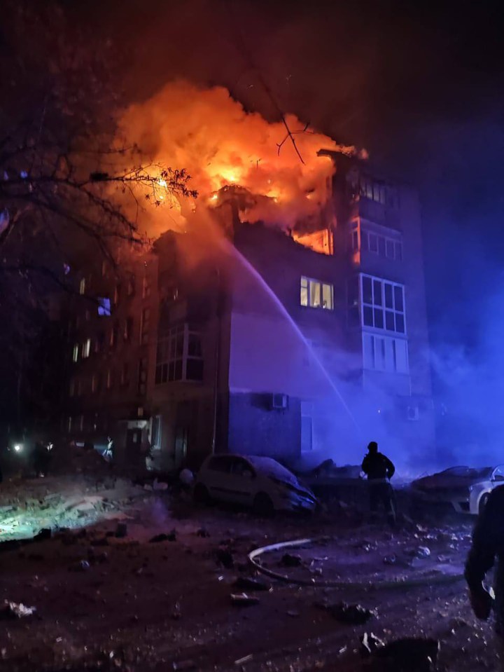 A five-story residential building on fire after being hit by a Russian drone.