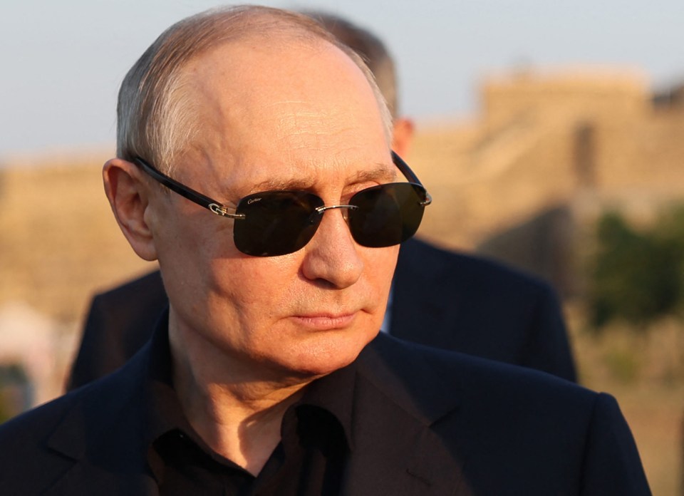 Vladimir Putin wearing sunglasses.