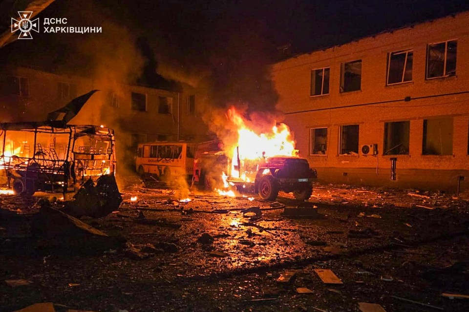 Burning vehicles and a building after a Russian drone attack in Ukraine.