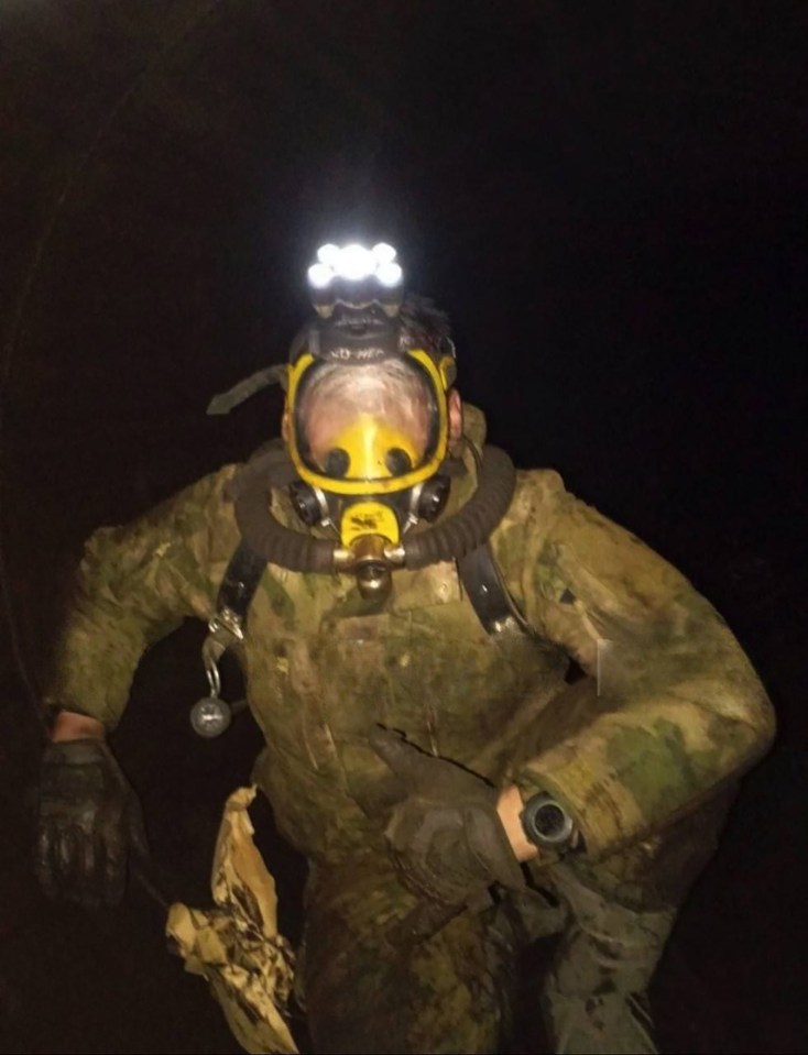 Russian soldier in a gas mask inside a damaged gas pipeline.
