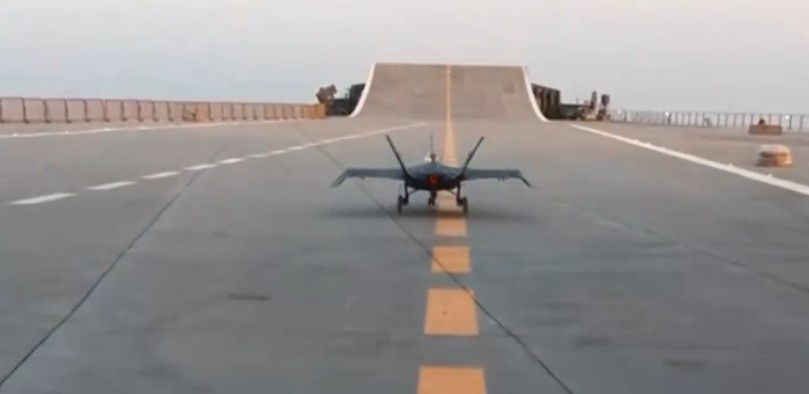 Small toy stealth fighter jet on a runway.