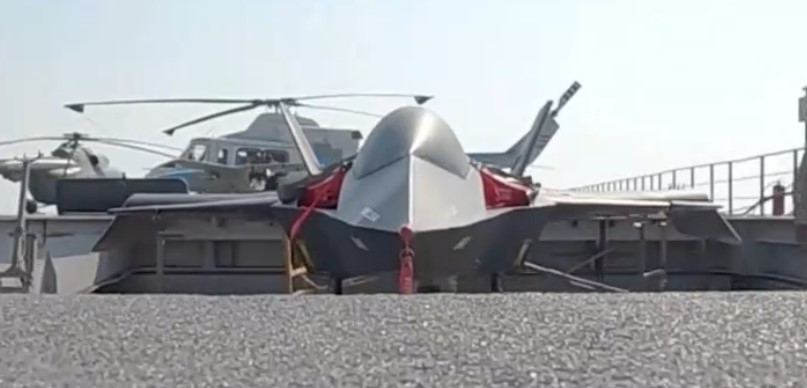 Small toy stealth fighter jet on a ship deck.