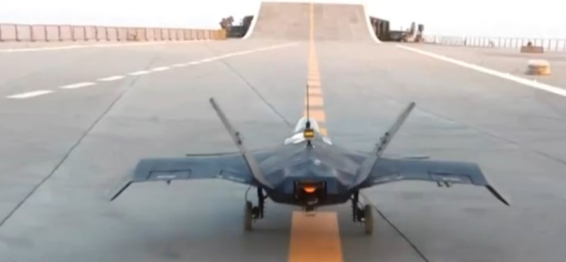 Small toy stealth fighter jet on a runway.