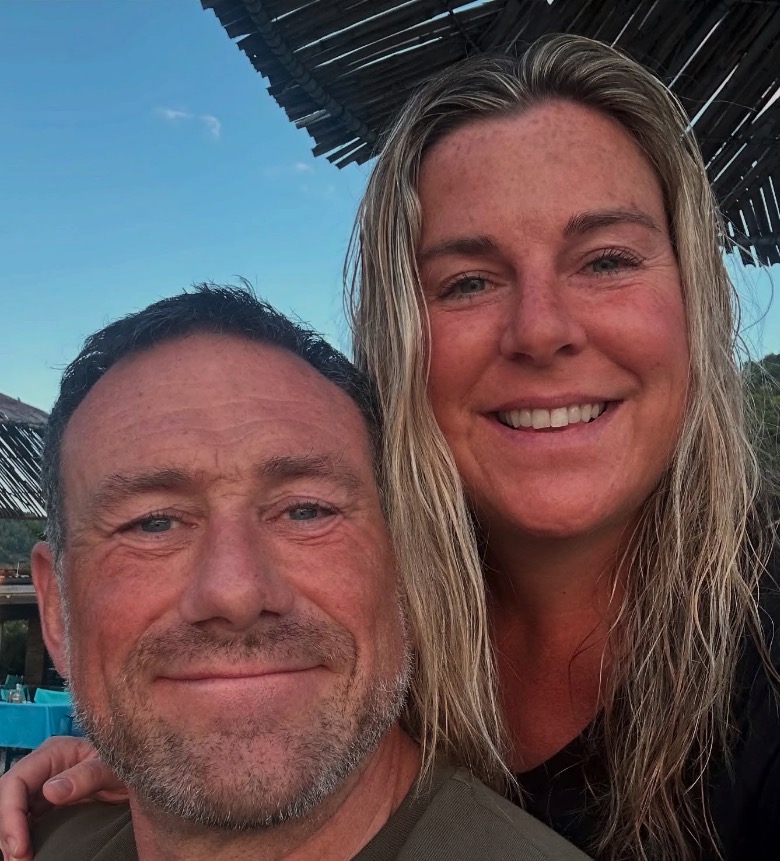 Photo of a man and woman smiling for a selfie.