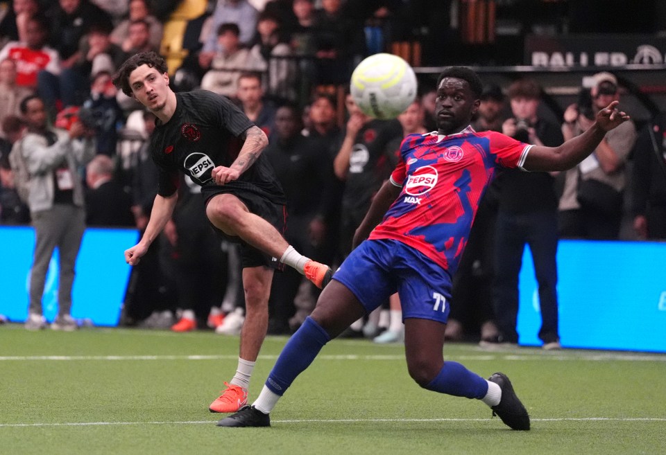 Soccer player kicking the ball past a defender.