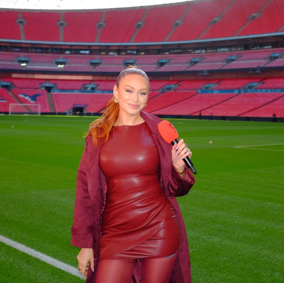 Elz the Witch, presenter at the Sidemen Charity Match, holding a microphone at Wembley Stadium.