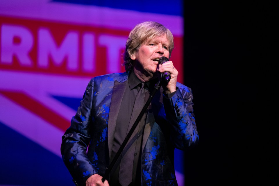 Peter Noone of Herman's Hermits performing onstage.