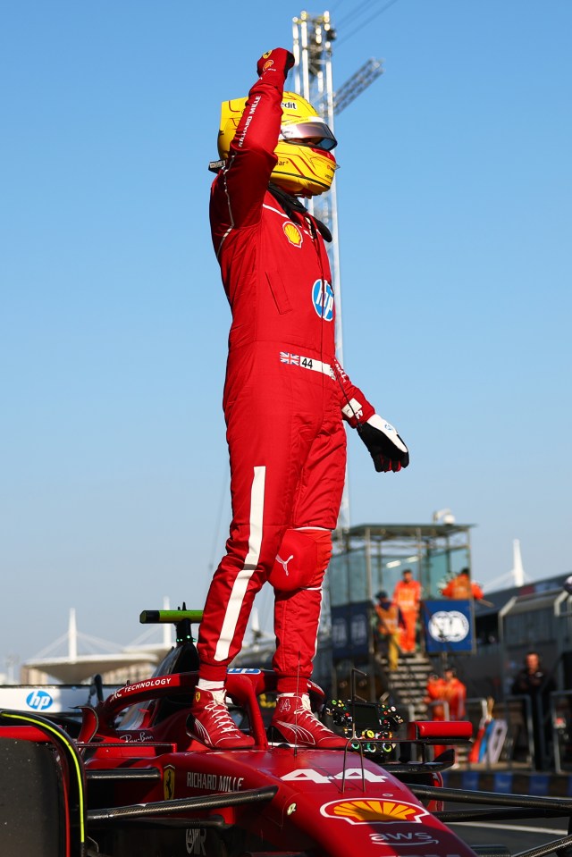 Lewis Hamilton celebrating on his Formula 1 car.