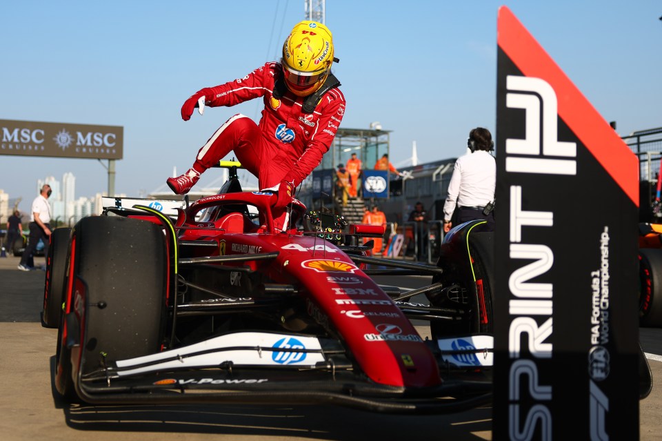 Lewis Hamilton celebrating on his Formula 1 car after winning the sprint pole qualifier.