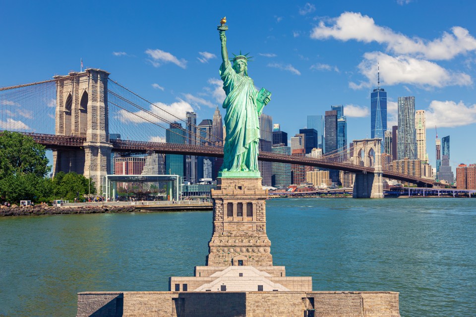 Statue of Liberty, Brooklyn Bridge, and Manhattan skyline.