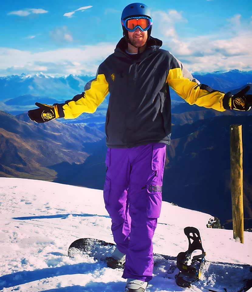 Snowboarder on mountaintop.