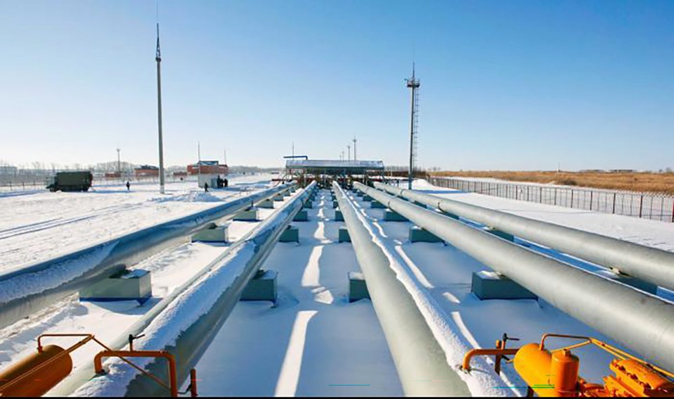 Gas pipelines in a snowy landscape.