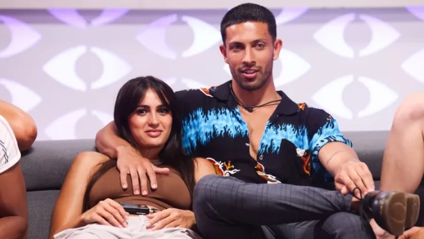 Two Big Brother contestants sitting together on a couch.