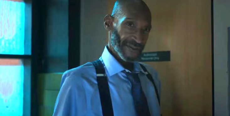 Man in a light blue shirt and suspenders.