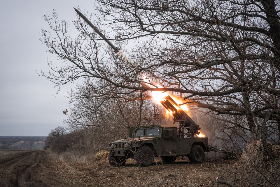 Ukrainian soldiers firing a rocket from a Humvee.