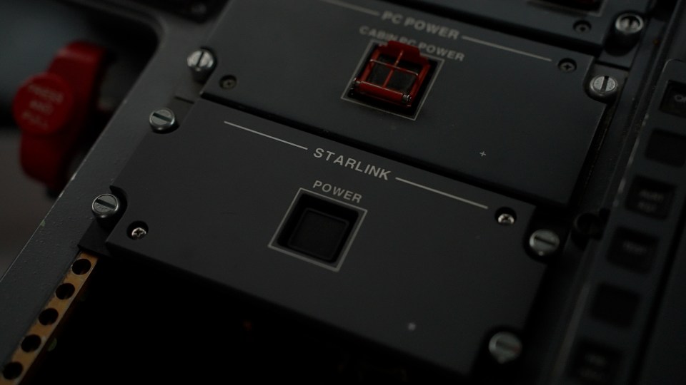 Close-up of a Starlink power switch on an aircraft's control panel.