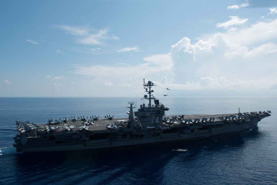 Aerial view of the USS John C. Stennis aircraft carrier at sea.