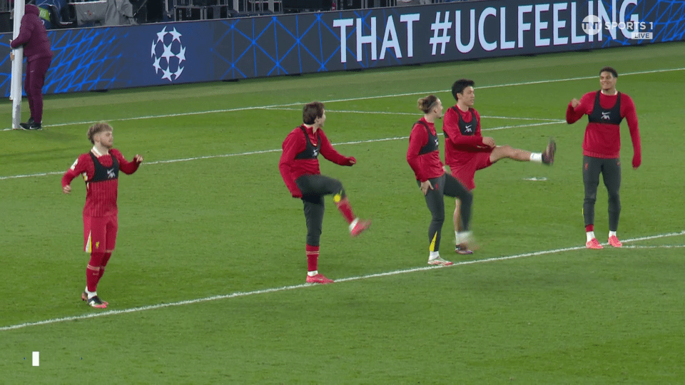 Soccer players warming up on the field.