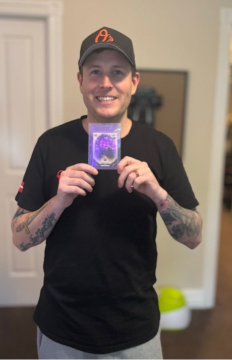 Man holding up a valuable trading card.