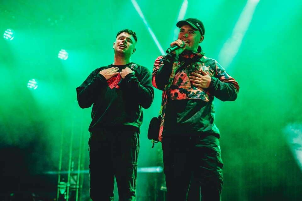 Kneecap performing on stage at Glastonbury Festival.