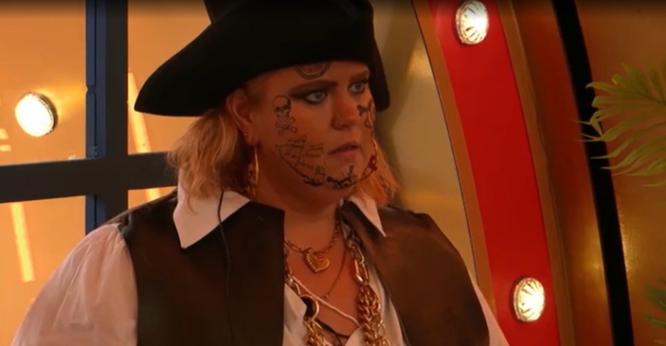 Woman in pirate costume with face tattoos.