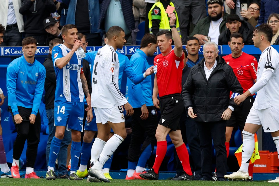 Kylian Mbappé receives a red card in a soccer match.