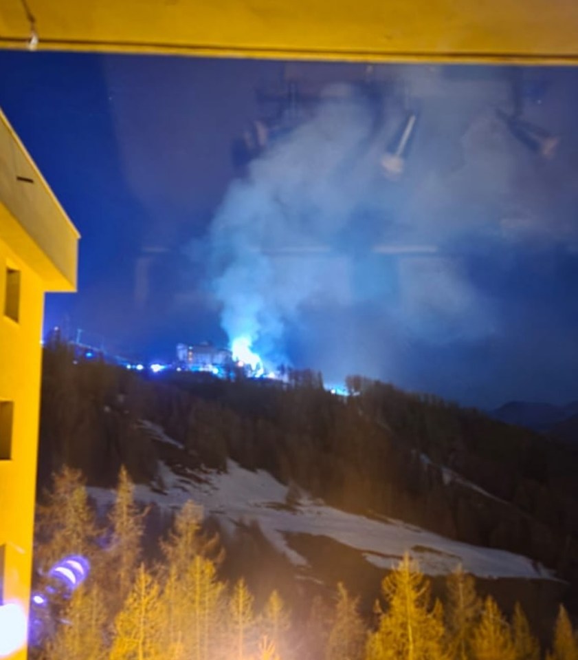 Nighttime view of a fire at a ski resort.