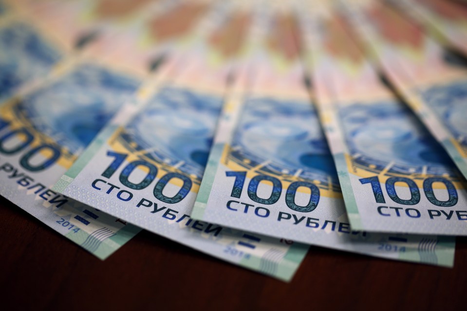 Close-up of several 100 ruble banknotes.