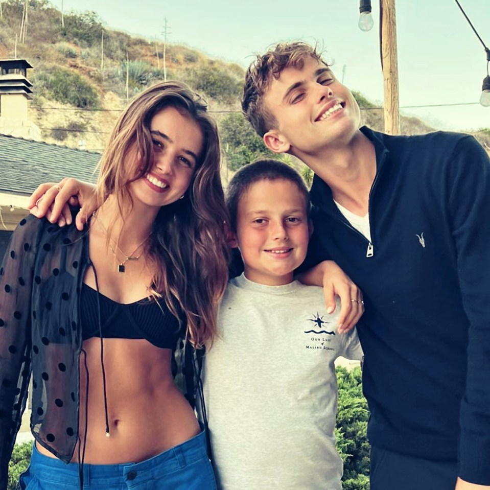 Three siblings posing for a photo.