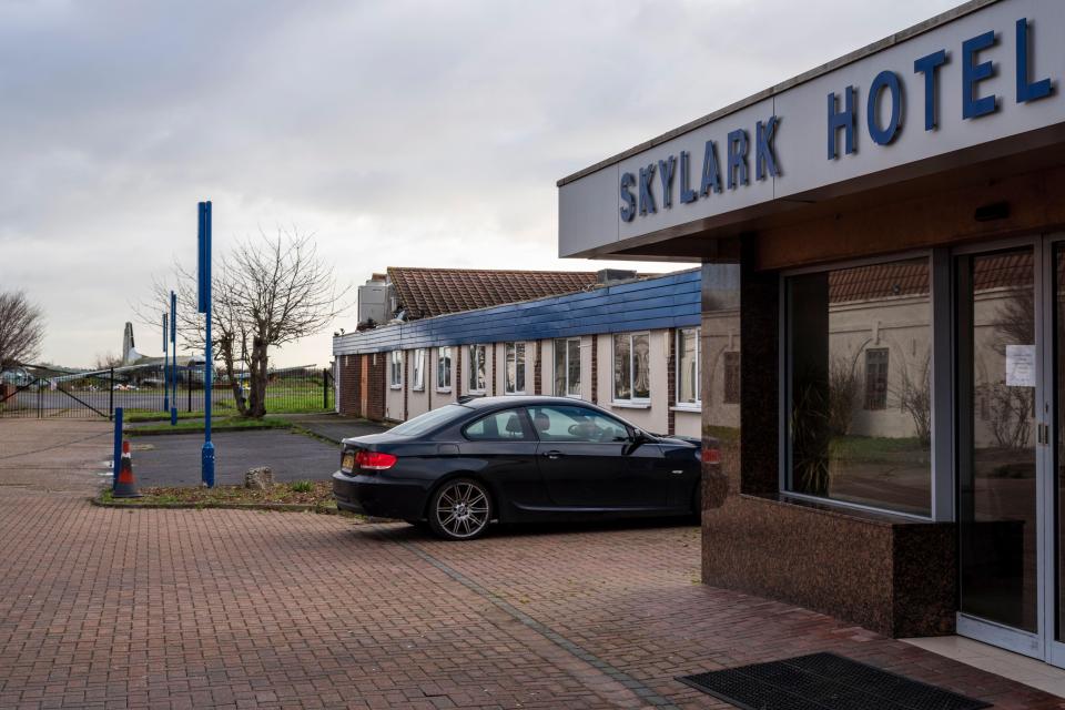 Skylark Hotel exterior with a car parked in front.