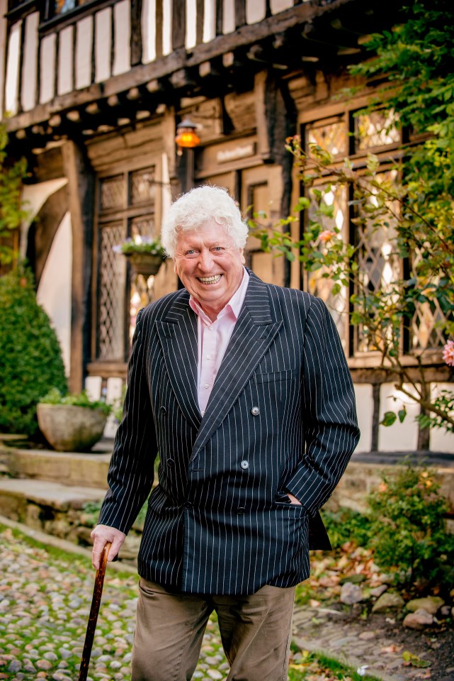 Photo of Tom Baker walking with a cane.