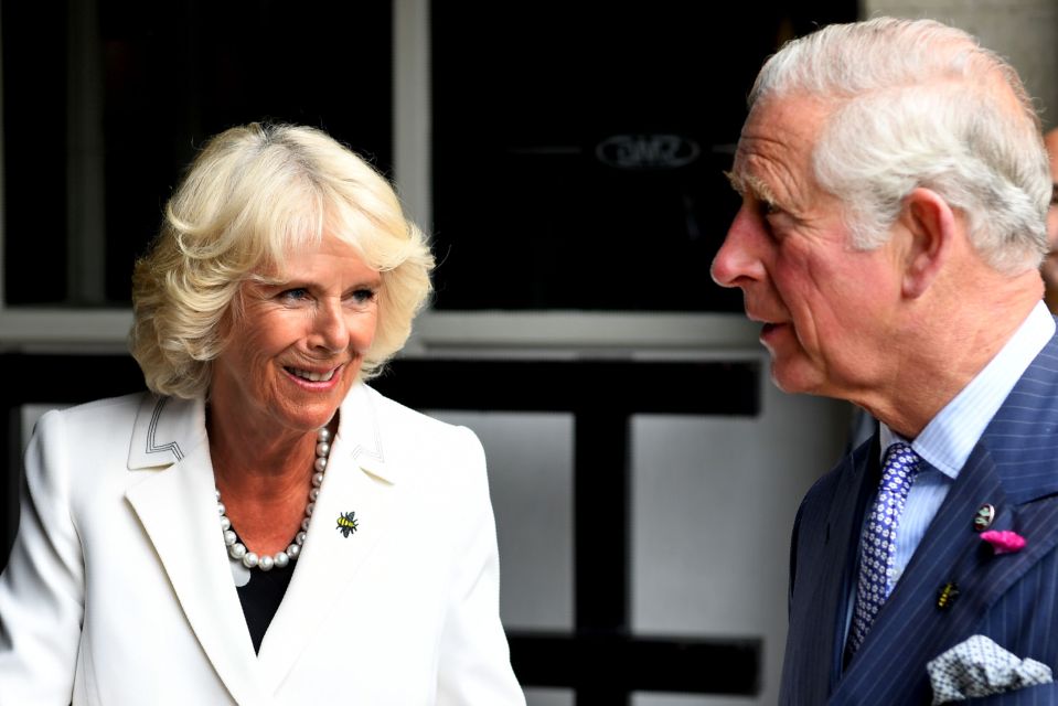 Prince Charles and Camilla, Duchess of Cornwall, leaving the Manchester Arena after meeting with people who helped victims of the Manchester Arena bombing.  Camilla wears a bee brooch.
