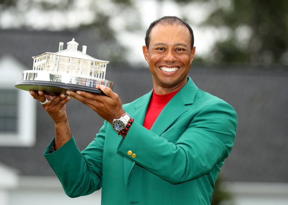 Tiger Woods holding the Masters Tournament trophy.