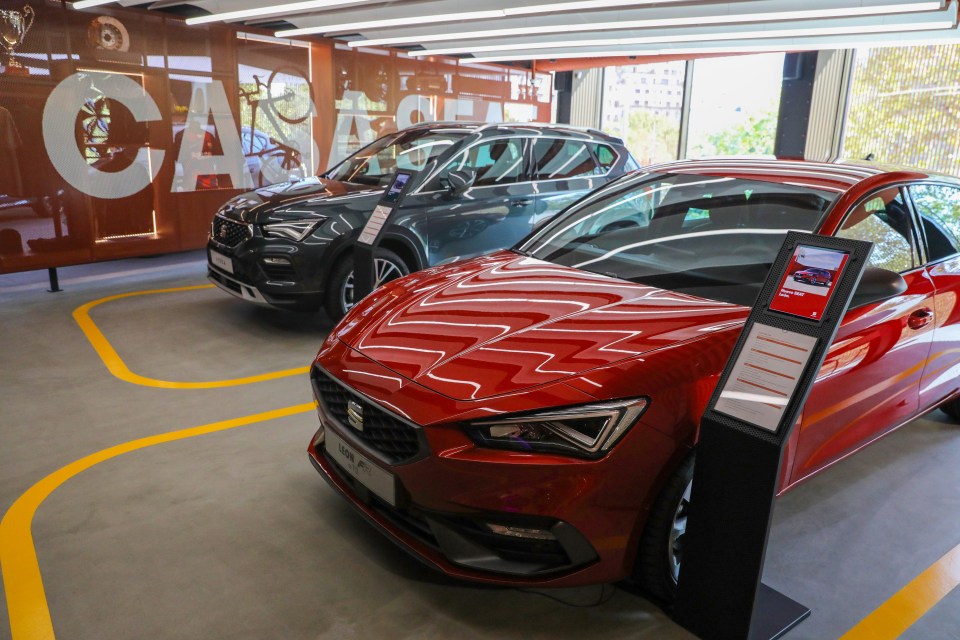 Two Seat cars on display in a showroom.