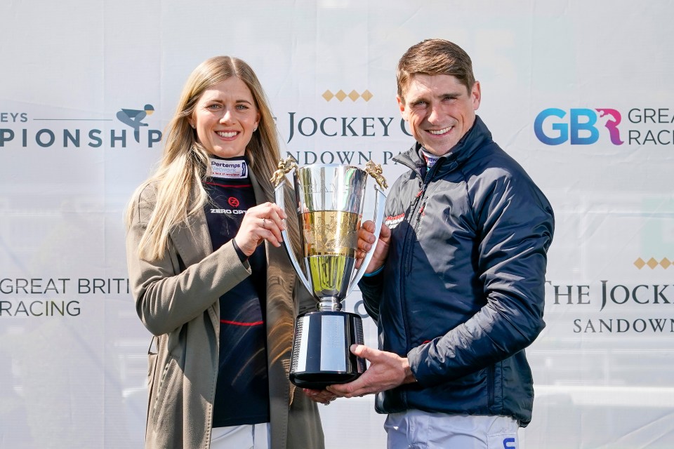 Harry Skelton and his wife Bridget Skelton holding the Champion Jockey trophy.