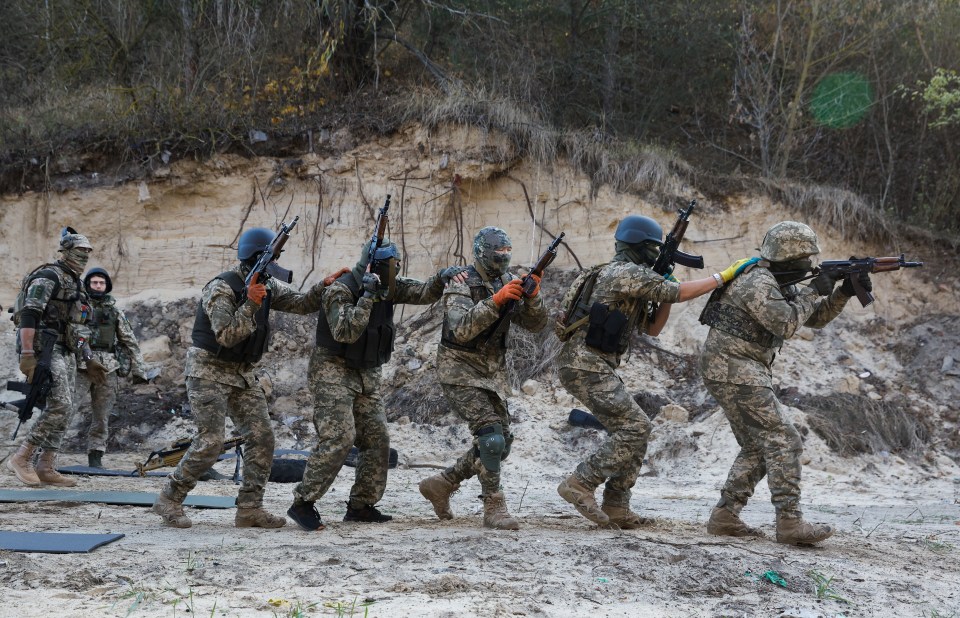 Members of the Siberian Battalion, a military unit within the International Legion of the Ukrainian Armed Forces, conduct military training near Kyiv.