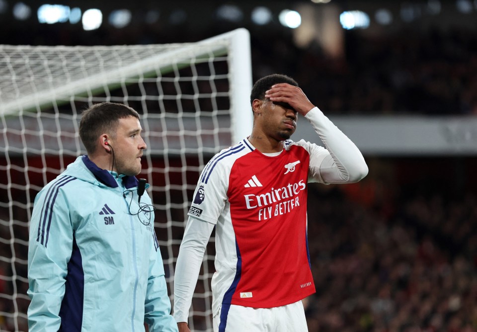 Arsenal's Gabriel Magalhaes reacts to an injury.