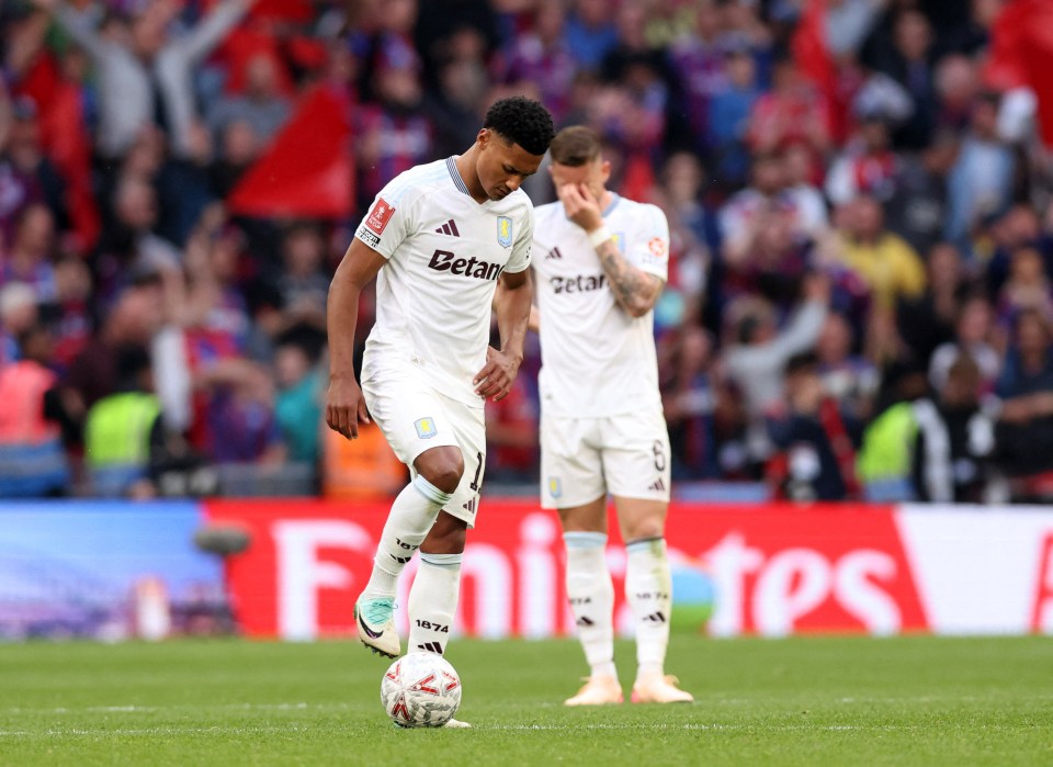 Aston Villa's Ollie Watkins looks dejected on the soccer field.