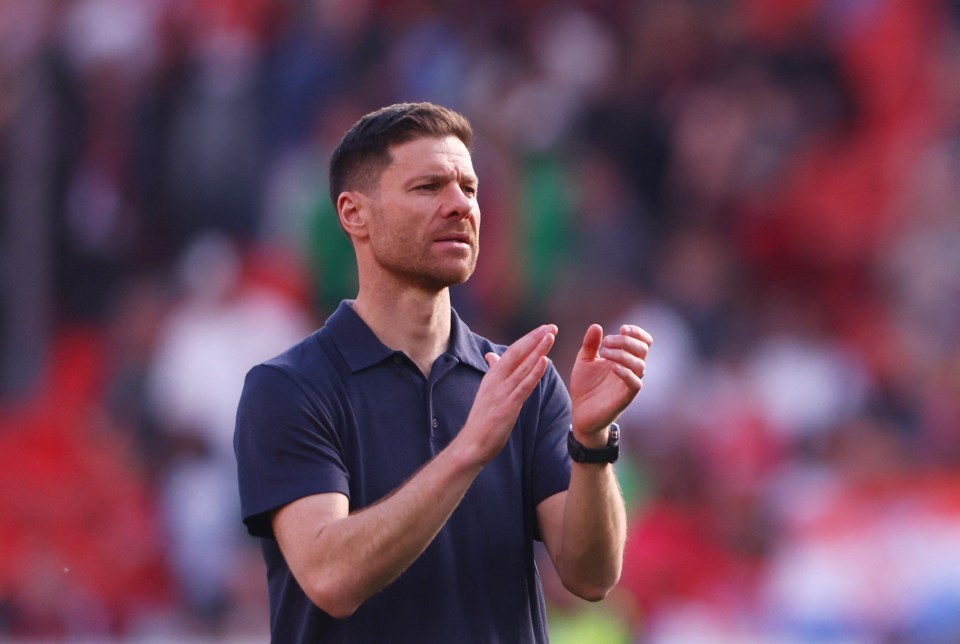 Xabi Alonso applauding after a soccer match.
