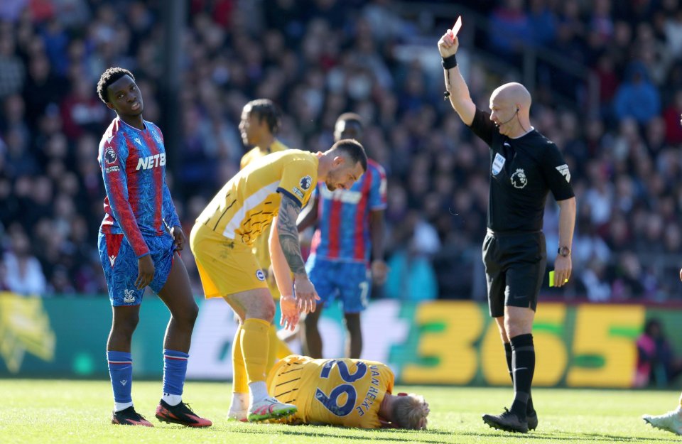 Eddie Nketiah of Crystal Palace receives a red card during a soccer match.